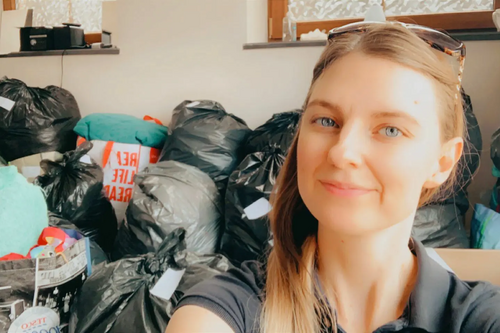 Team member Caroline with some of the collected items for Afghan refugees